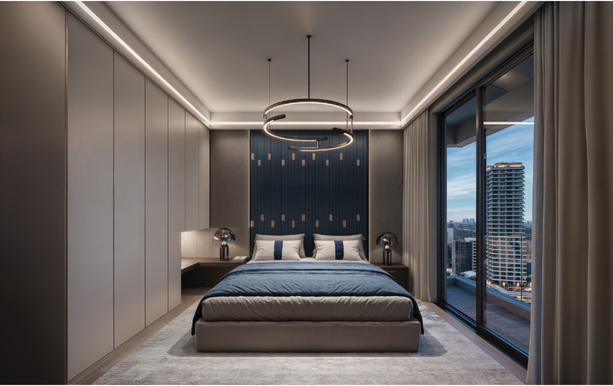 "Luxury master bedroom at Montbleu Westlands with pendant lighting, dark blue accent wall, king bed, city skyline views through floor-to-ceiling windows, and modern neutral décor"