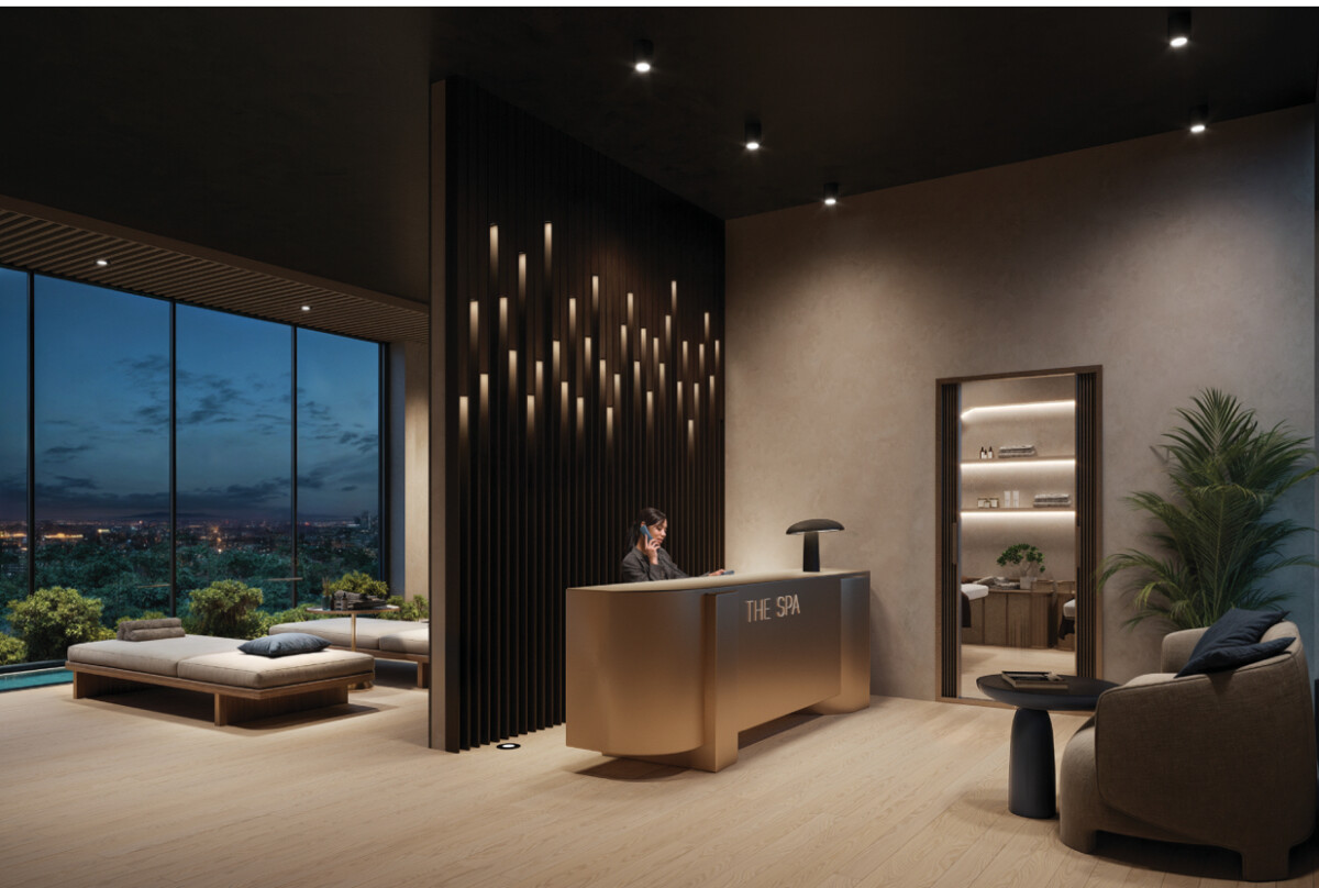 "Luxury spa reception at Montbleu Westlands with city views, wooden deck seating, modern pendant chandelier, dark wood accents, and ambient lighting"