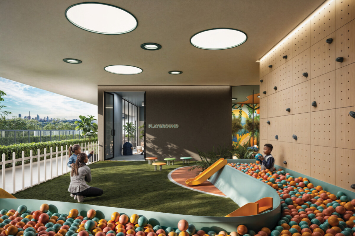 "Children's playground amenity at Montbleu Westlands featuring colorful ball pit, climbing wall, natural lighting, modern play equipment, and scenic city views"